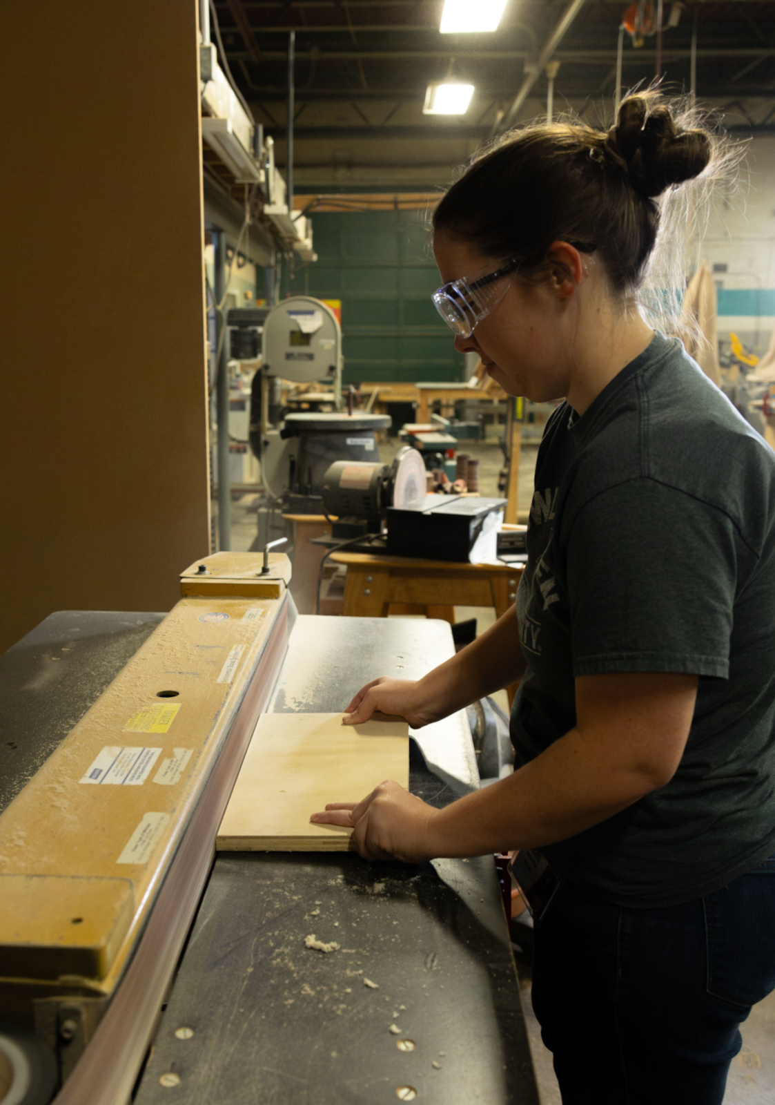 An open hours member works with the belt sander